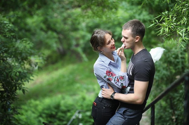 Beautiful young couple on a walk in the spring park