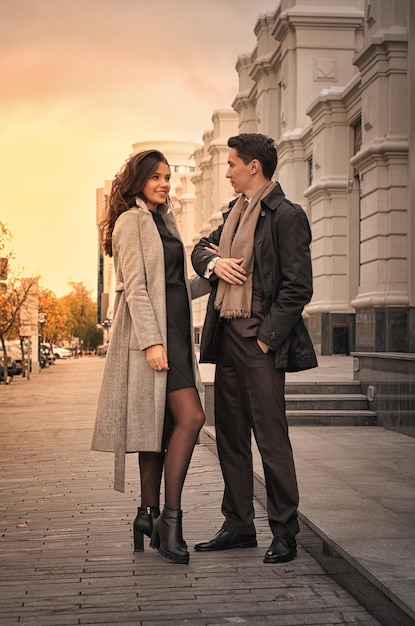 A beautiful young couple walking around the cityman and woman in business style