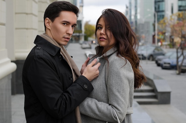 A beautiful young couple walking around the cityman and woman in business style