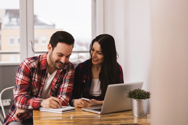 Beautiful young couple working together.