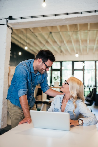 Beautiful young coworkers talking at work.