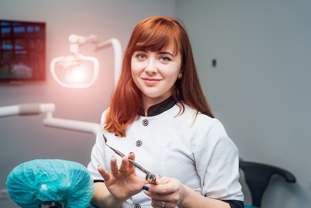 Beautiful young dentist woman posing in modern dental office.