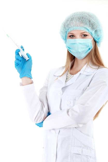 Beautiful young doctor in medical robe holding syringe isolated on white