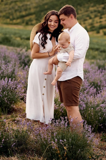 Beautiful young family in a lavender field spends the day