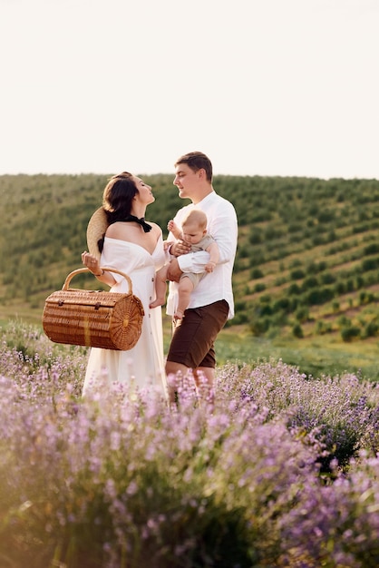 Beautiful young family in a lavender field spends the day