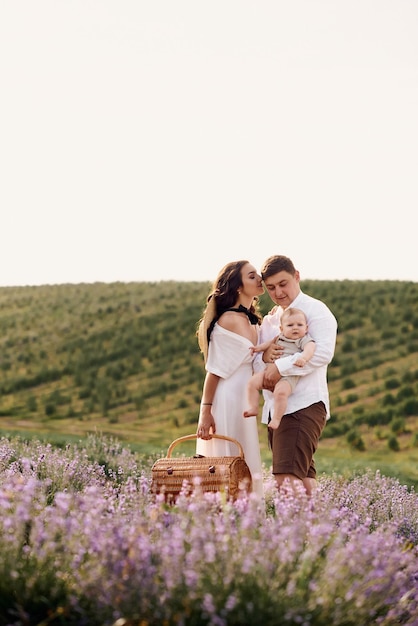 Beautiful young family in a lavender field spends the day