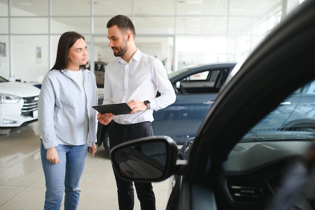 beautiful young female client customer choosing new car