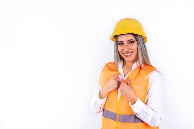 Beautiful young female engineer or supervisor wearing safety equipment on white background