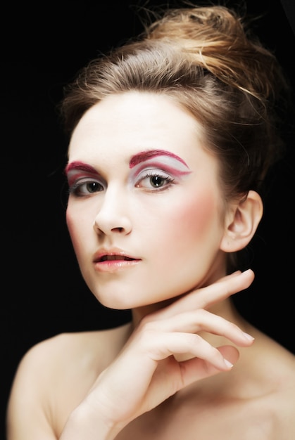 Beautiful young female face with bright fashion multicolored make-up