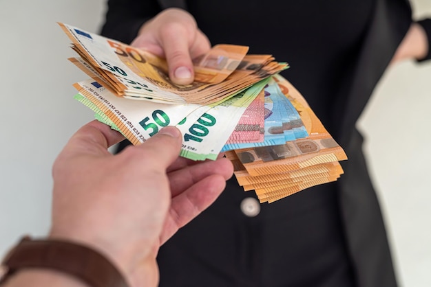 Beautiful young female hands holding a lot of euros to invest in business Business lady concept