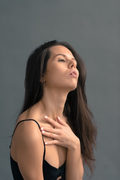 Beautiful young fitness instructor woman posing in studio. Close up details