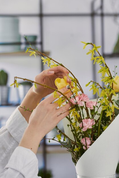 Beautiful young florist makes a bouquet