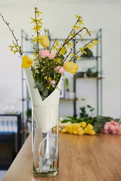 Beautiful young florist makes a bouquet