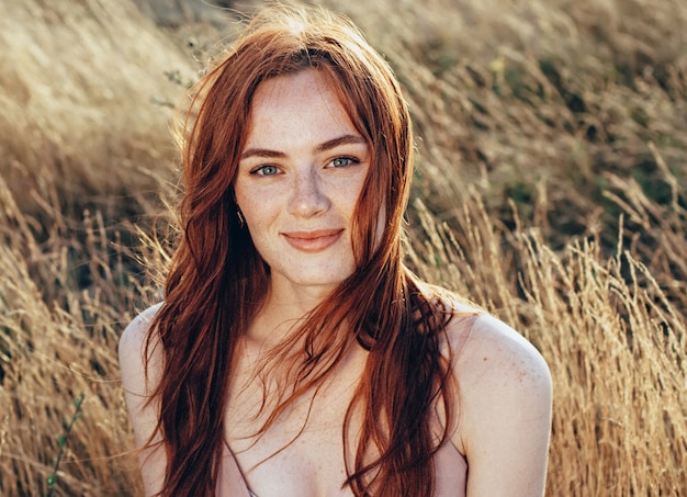 Beautiful and young ginger woman with natural face freckles