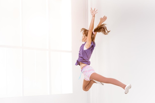 Beautiful young girl dancing in dance studio.