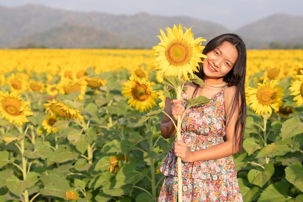 Beautiful young girl enjoy time at the field flowers