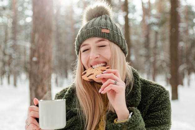 Beautiful young girl enjoying winter outdoors Pretty women having fun and smilling