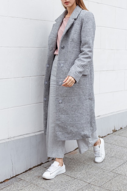 Beautiful young girl in fashionable outfit on the street