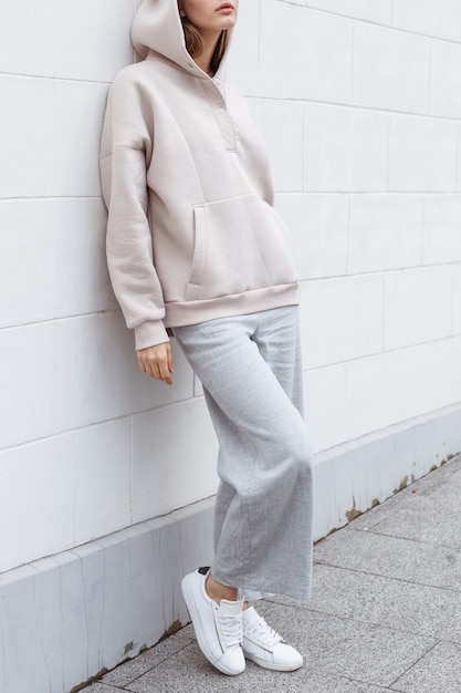 Beautiful young girl in fashionable outfit on the street