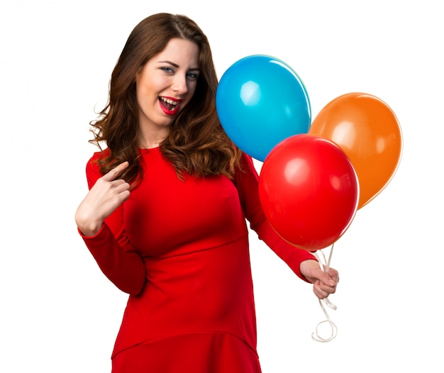 Beautiful young girl holding balloons and proud of herself