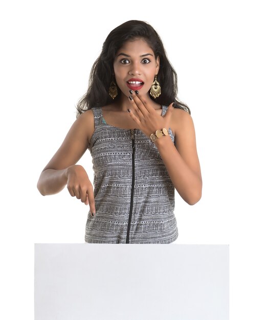 Beautiful young Girl holding white big signboard and posing