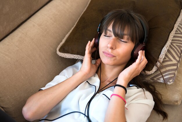 Beautiful young girl listening music