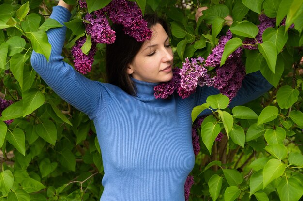 Beautiful young girl near the lilac