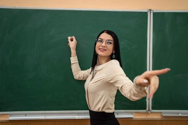 最初のレッスンで新しい学校の先生の美しい少女