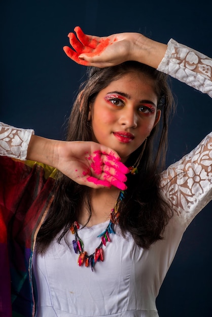 A beautiful young girl plays with colors on the occasion of Holi The concept for the Indian festival Holi