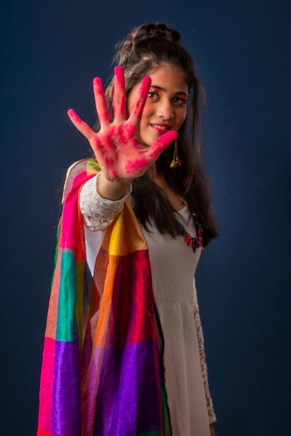 A beautiful young girl plays with colors on the occasion of Holi The concept for the Indian festival Holi