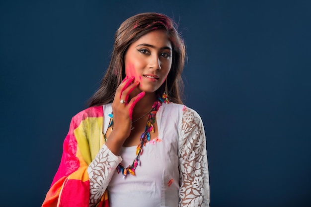 A beautiful young girl plays with colors on the occasion of Holi The concept for the Indian festival Holi