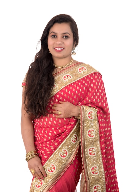 Beautiful young girl posing in Indian traditional saree on white.