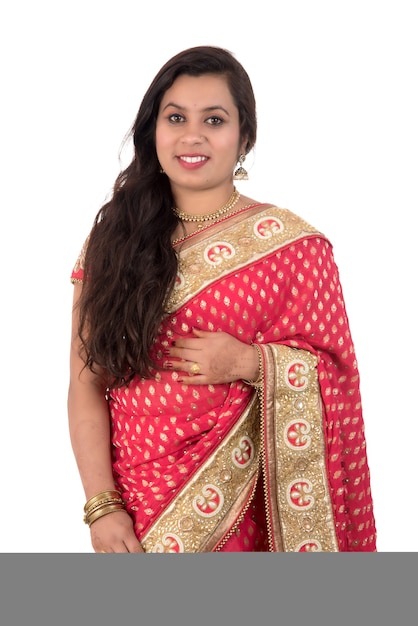 Beautiful young girl posing in Indian traditional saree on white.