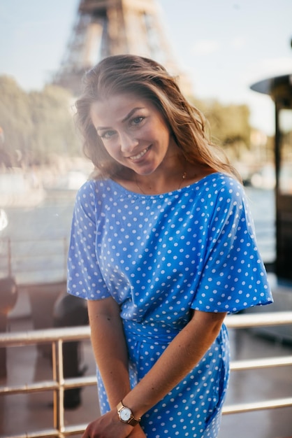 Beautiful young girl posing near the eiffel tower