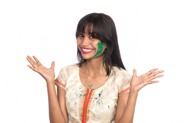 Beautiful young girl posing with colorful face in the occasion of Holi festival