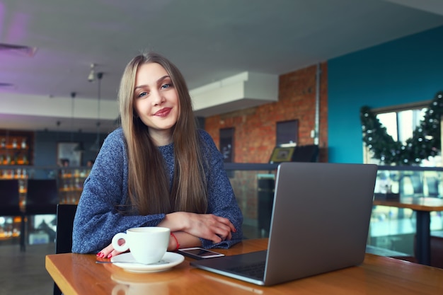 Beautiful young girl resting in a cafe