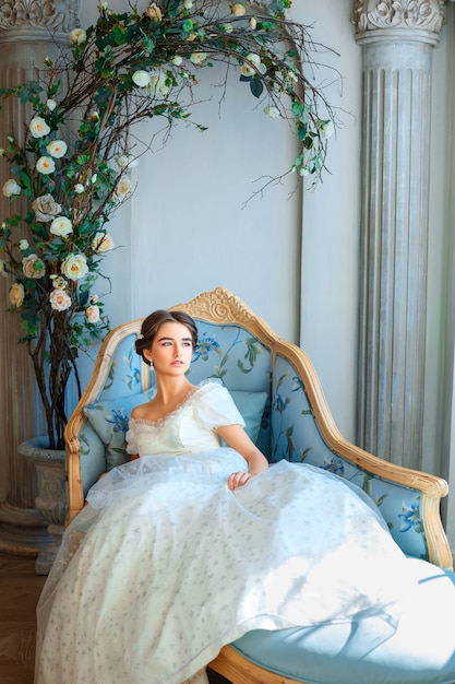 beautiful young girl in rich dress lying on sofa, relax concept