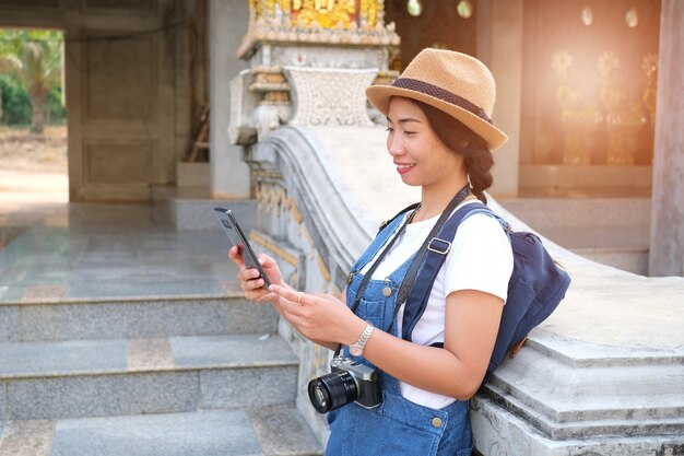 Beautiful young girl sightseeing Pagoda  Watchaimongkol Roiet famous landmark at Roiet Thailand