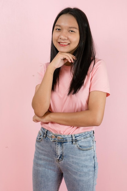 Beautiful young girl smiling standing on pink background