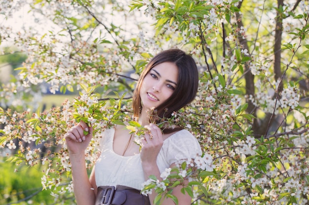 Beautiful young girl in spring garden