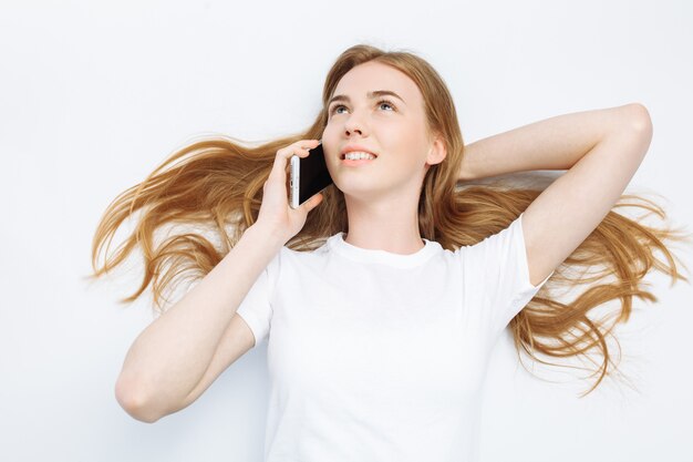 Beautiful young girl talking on the phone, cheerful and positive