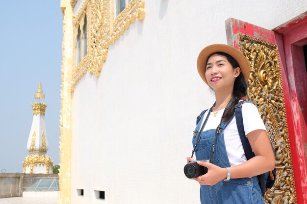 Beautiful young girl tourist at travel at a beautiful temple at Thailand