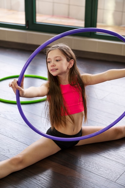 Foto bella ragazza che usa l'hula hop