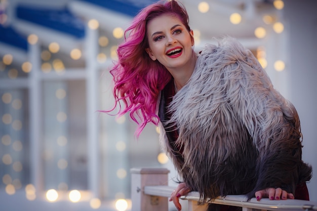 Beautiful young girl walks in evening city