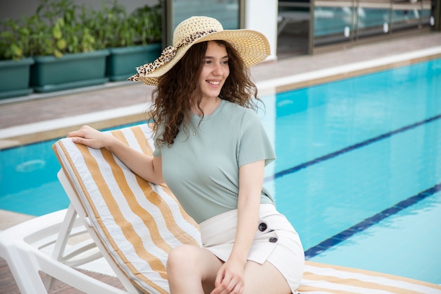 A beautiful young girl wearing a hat