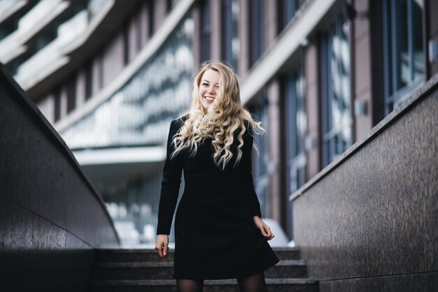 Beautiful young girl with blonde wavy hair outdoors