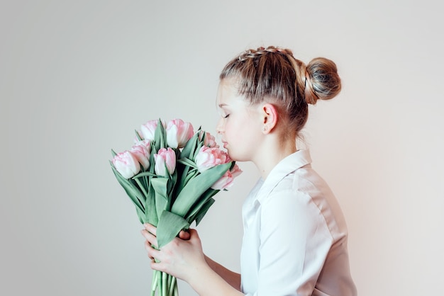 春の花、女性の日、母の日のグリーティングカードの束を持つ美しい少女