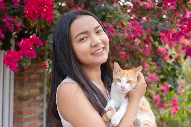 Beautiful young girl with a cat out door