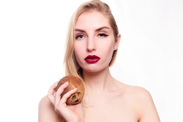 Beautiful young girl with coconut in her hand