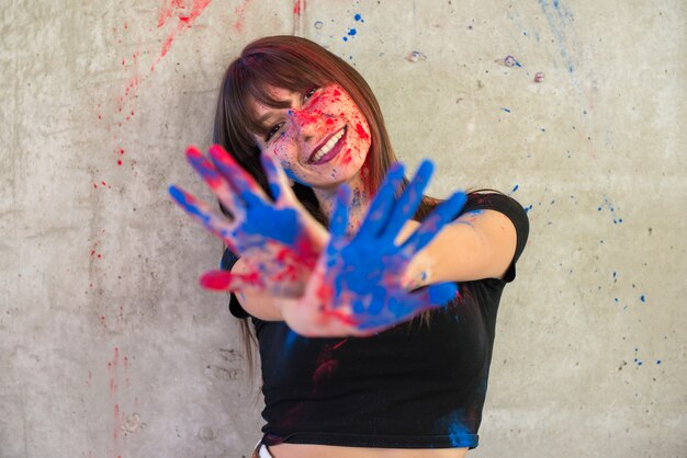 Beautiful young girl with color holi